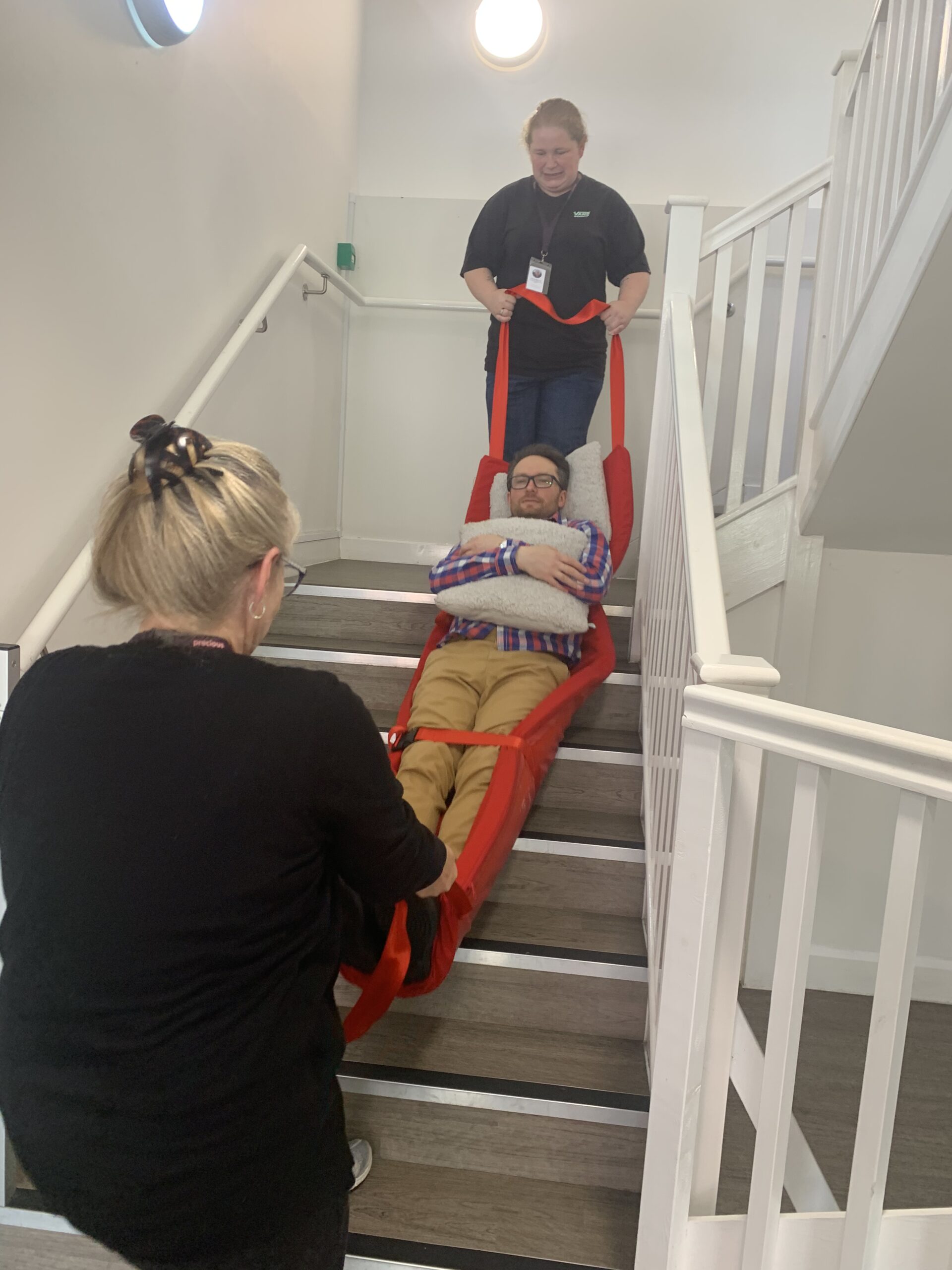 Emergency evacuation sledge training on the staircase during the Safe Exit Training course